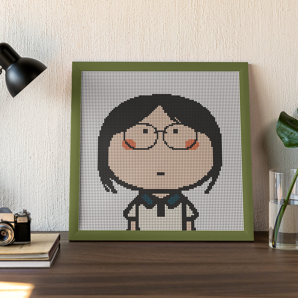 Finished framed diamond art of a girl lost in thought, great for desktop decor or cozy personal space.