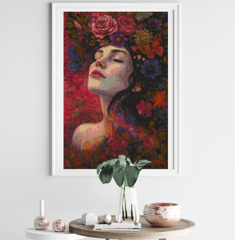 A stunning floral diamond painting featuring a serene woman surrounded by vibrant blooms, elegantly framed and displayed in a cozy, minimalist room — perfect as statement wall art.