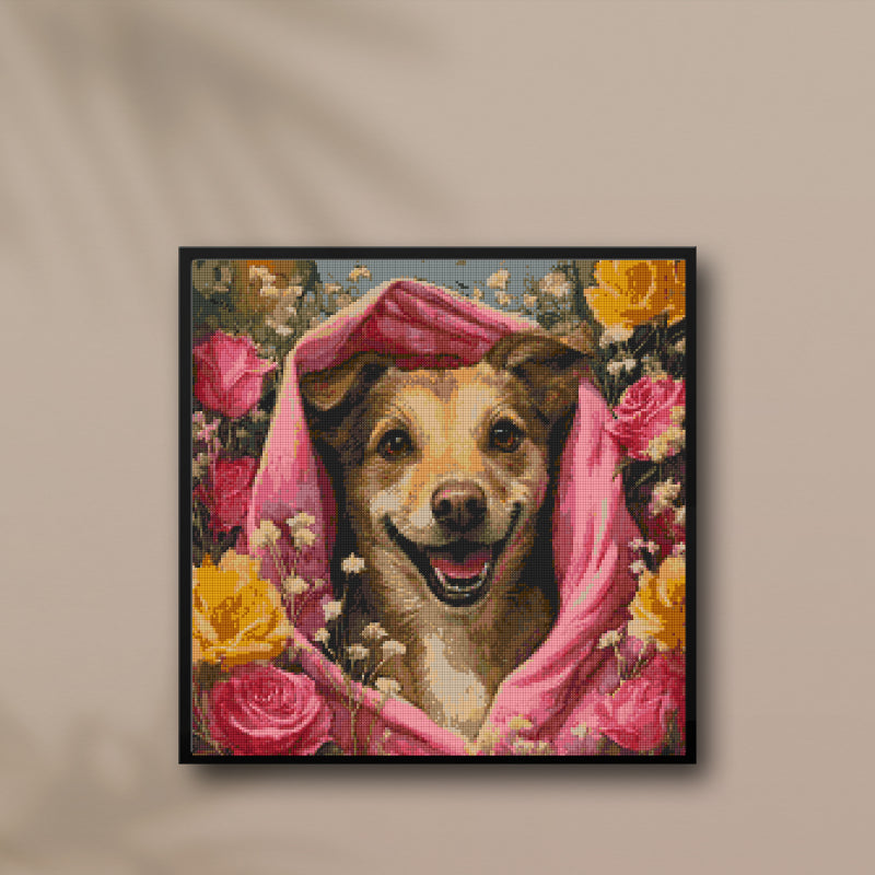 Framed diamond painting of a smiling dog wrapped in pink cloth, surrounded by roses, displayed above a modern neutral-toned cabinet — perfect cheerful wall decor.