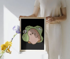 Framed mini cute Sad Ghost diamond painting, displayed as wall art. Pastel green-beige tones, 20x30cm, 2,030 round drills, 8 colors plus 1 AB or Fairy Dust drill. Gentle and expressive decoration or thoughtful gift.