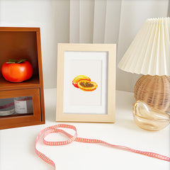 Passionfruit diamond painting framed on a minimalist desk with a lamp and ribbon, ideal for fruit-themed home decor or gift idea.on a minimalist desk with a lamp and ribbon, ideal for fruit-themed home decor or gift idea.