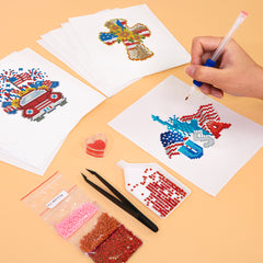 Hands working on diamond painting a peace-sign gnome with red, white, and blue gems from the American Magic kit