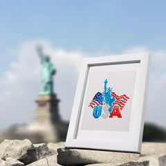 Finished DIY All American Magic diamond painting in frame, placed near the Statue of Liberty for patriotic decor