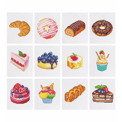 Flat lay of all 12 bakery-themed diamond painting mini canvases including donuts, cakes, rolls, croissant, and cupcakes on white background.