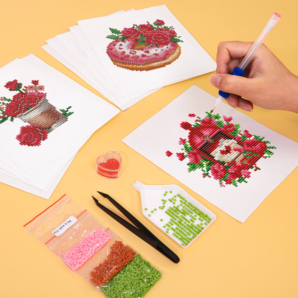 Hands working on a mini diamond painting canvas from the Bloom & Bite set, featuring a red rose bouquet – ideal for stress relief and mindful DIY moments.
