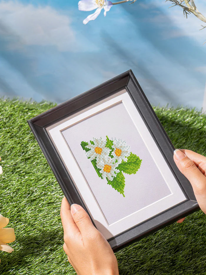 Small white Sunflower diamond painting artwork held in sunlight, ideal for beginner& nature lovers who enjoy floral DIY kits.