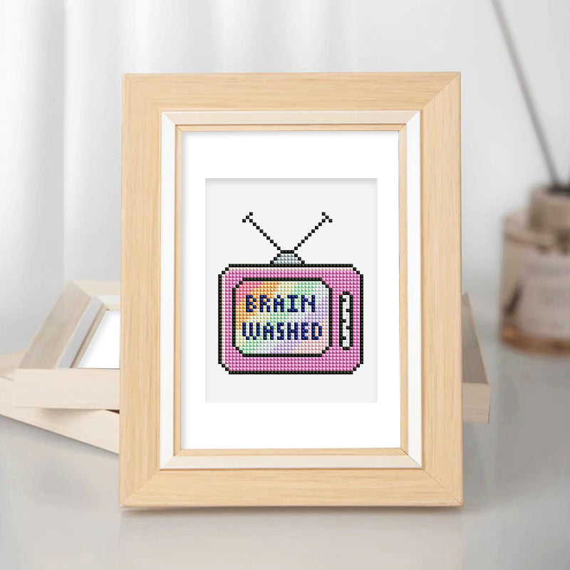 Pink vintage TV with “BRAINWASHED” text – quirky 90s-style diamond painting canvas.