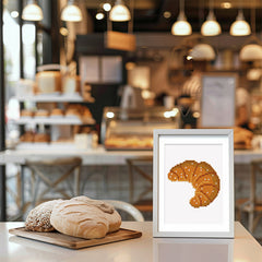 Framed croissant diamond painting displayed on a bakery table with real croissant and flour props.