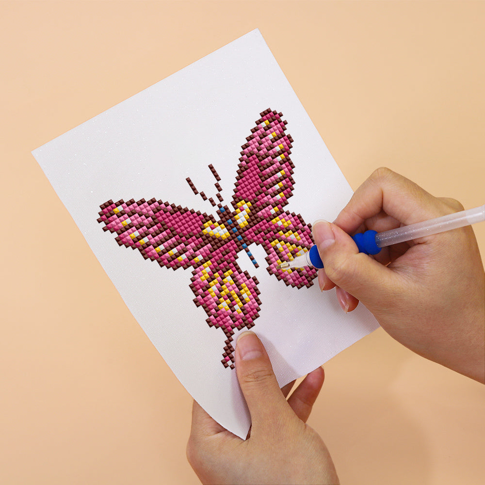 Hand placing drills on a purple butterfly diamond painting