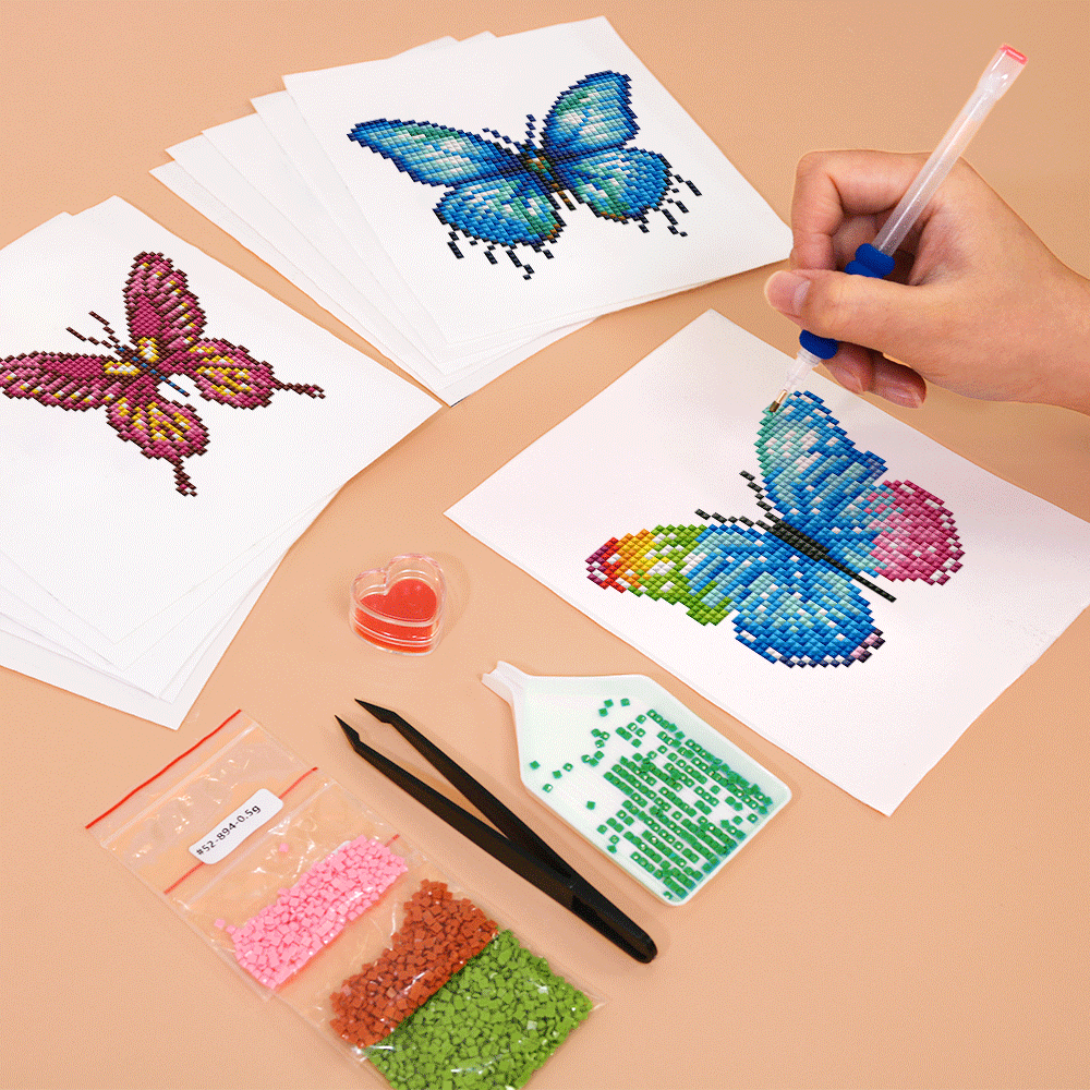 Hands placing drills on a bright butterfly canvas – step-by-step diamond painting for mindful crafting.