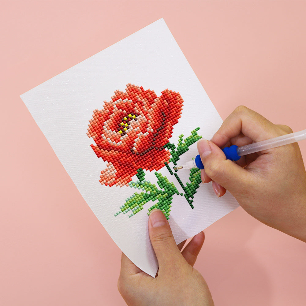 Close-up of DIY red  flower diamond painting on soft canvas – a calming and colorful craft for floral art lovers