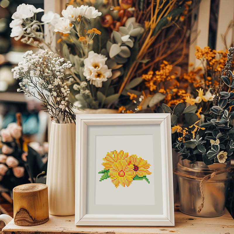 Framed yellow flower diamond painting on table – cozy home decoration with a handmade touch.