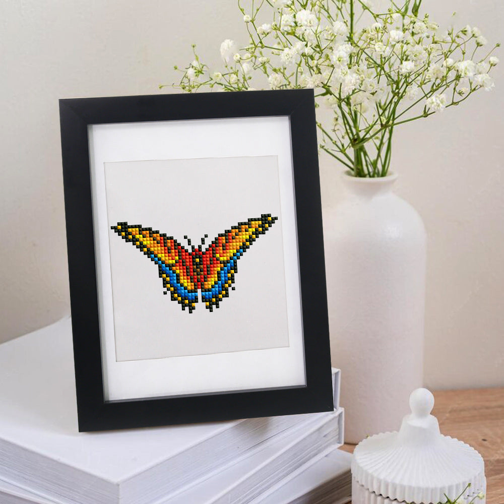 Framed butterfly mini diamond painting displayed on a white table – elegant and giftable handmade decor.