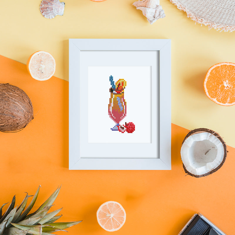 Finished cocktail diamond painting framed and displayed by the poolside, perfect for summer ambiance or gifting.