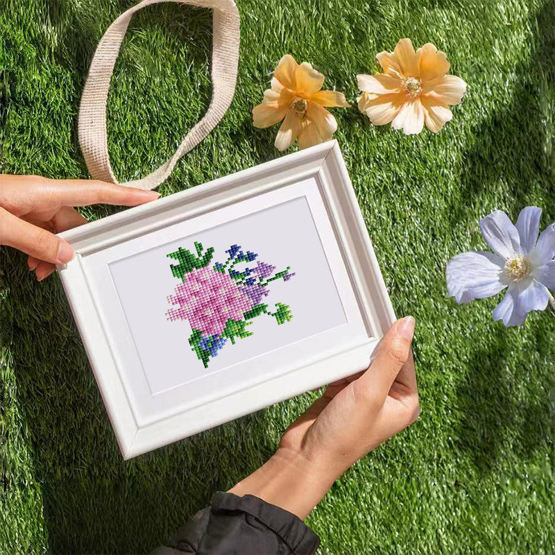 Framed blooming flower diamond painting displayed outdoors – creative gift and home décor idea.