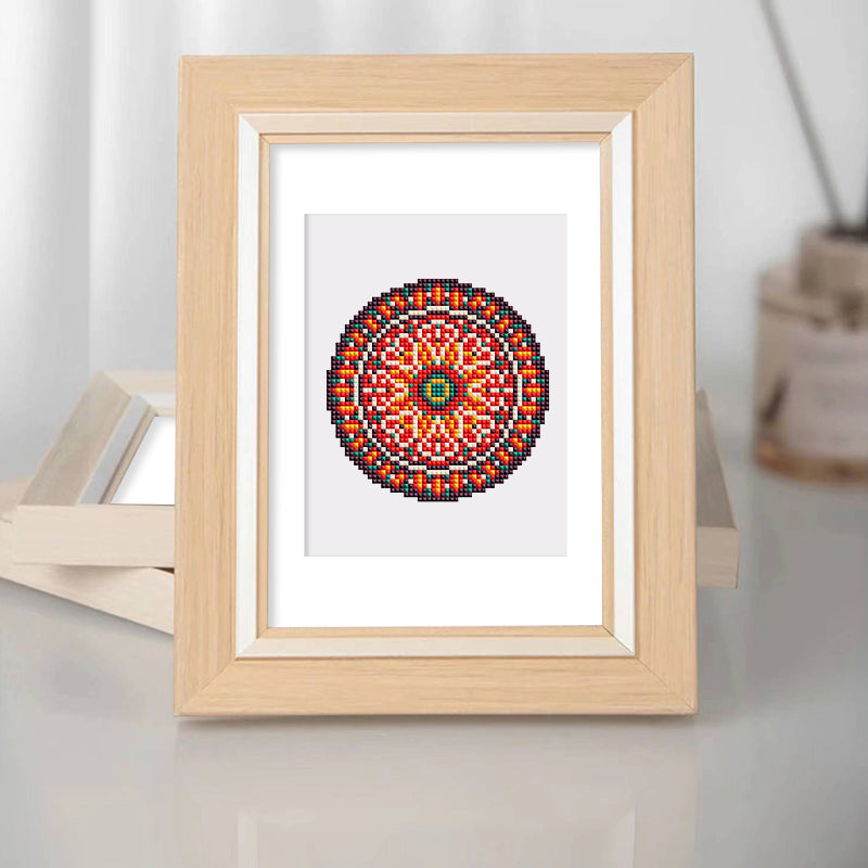 Framed mandala diamond painting displayed on wooden stand, ideal for home or office decor
