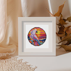 Finished diamond painting in white frame on cozy fabric background