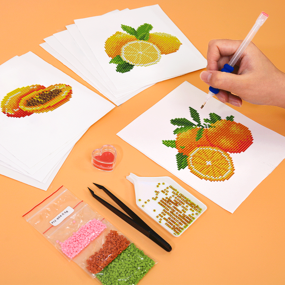 Close-up of hands working on fruity mini diamond painting, such as orange and lemon,ideal for mindfulness, DIY fans, and creative summer activities.