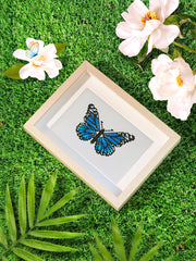 Blue butterfly diamond painting canvas styled with flowers and grass – a vibrant piece from the Mini Butterfly Kingdom 2 collection.