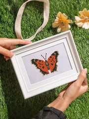 Hand holding framed brown butterfly diamond painting from Mini Butterfly Kingdom 2 – a charming addition to creative wall decor.