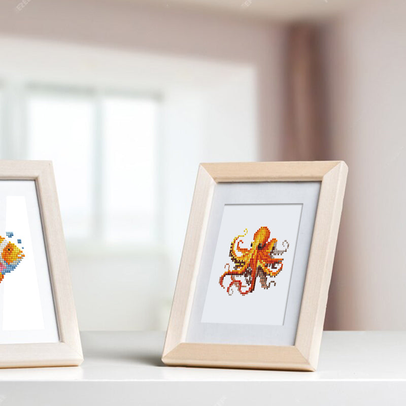 Framed ocean animal canvas displayed on bright windowsill. Ocean Whispers diamond painting kit used for DIY wall decor.