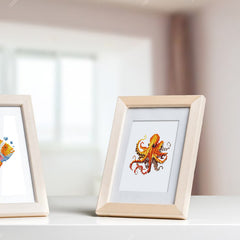 Framed ocean animal canvas displayed on bright windowsill. Ocean Whispers diamond painting kit used for DIY wall decor.