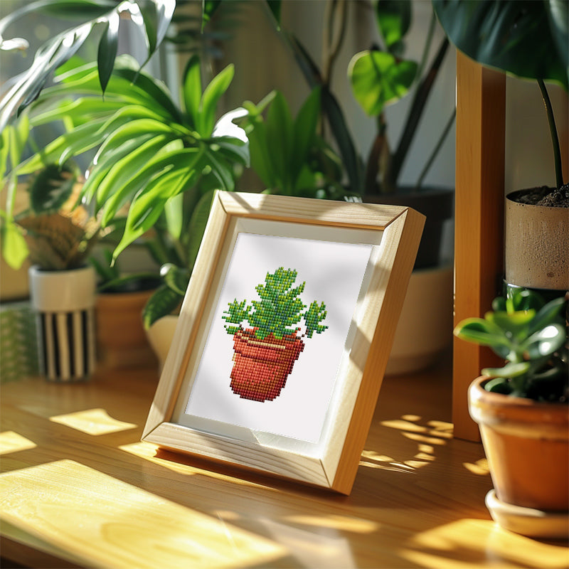 This depicts the finished effect of a mini diamond painting, specifically a plant series. Once the diamond painting is finished and framed, it sparkles beautifully on the desktop. It's perfect for decoration and beginners.
