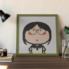 Finished framed diamond art of a girl lost in thought, great for desktop decor or cozy personal space.