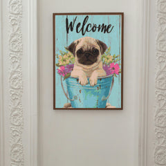 Framed diamond painting featuring a cute pug in a blue bucket with flowers, ideal for pet lovers seeking cheerful wall decor or a handmade welcome sign.