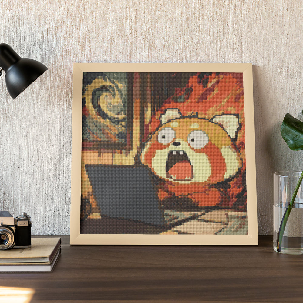 A hilarious diamond painting of a red panda in full panic mode, shown yelling at a laptop with flames in the background. This framed small diamond painting captures the chaotic energy of modern life and is a relatable and funny addition to any desktop or office space.