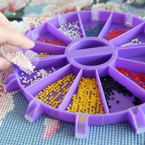Hand using diamond painting tray to pour drills, with complete kit of tray, pens, tips, spoon, brush, wax, and protectors. Practical for fast bead sorting and precise placement, making the crafting process smoother, portable, and ideal for long DIY sessions.