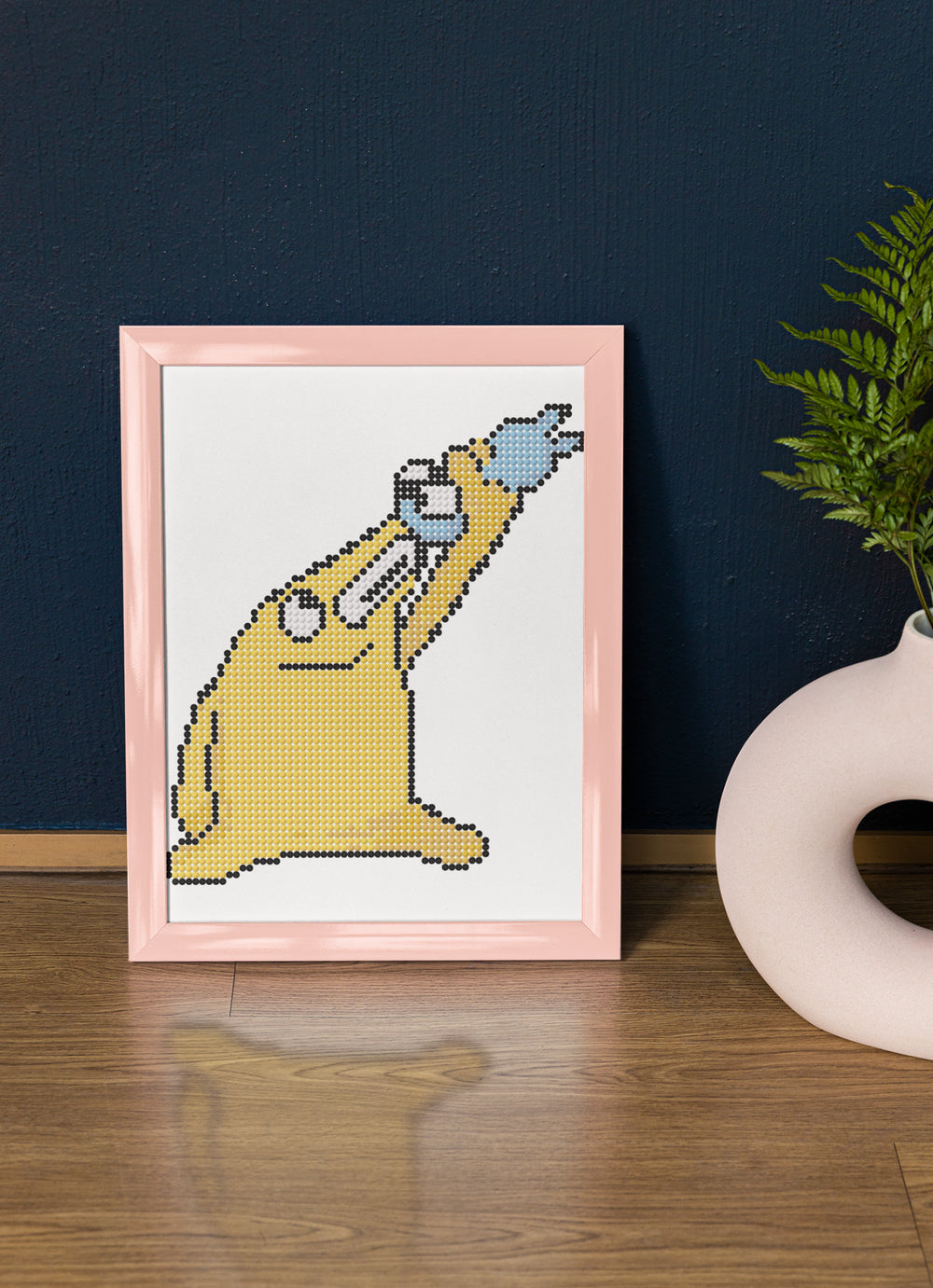 Framed version of the Mischievous Creature, featuring expressive arms and a wide smile. A perfect funny gift or desktop decor for whimsical minds. This small diamond painting brings personality to child’s rooms, creative corners, or art-themed shelves.