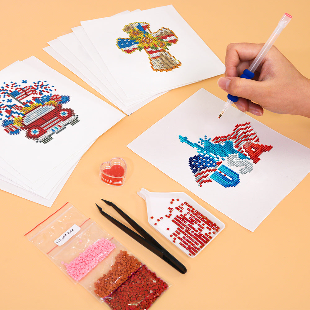 Hands working on diamond painting a peace-sign gnome with red, white, and blue gems from the American Magic kit