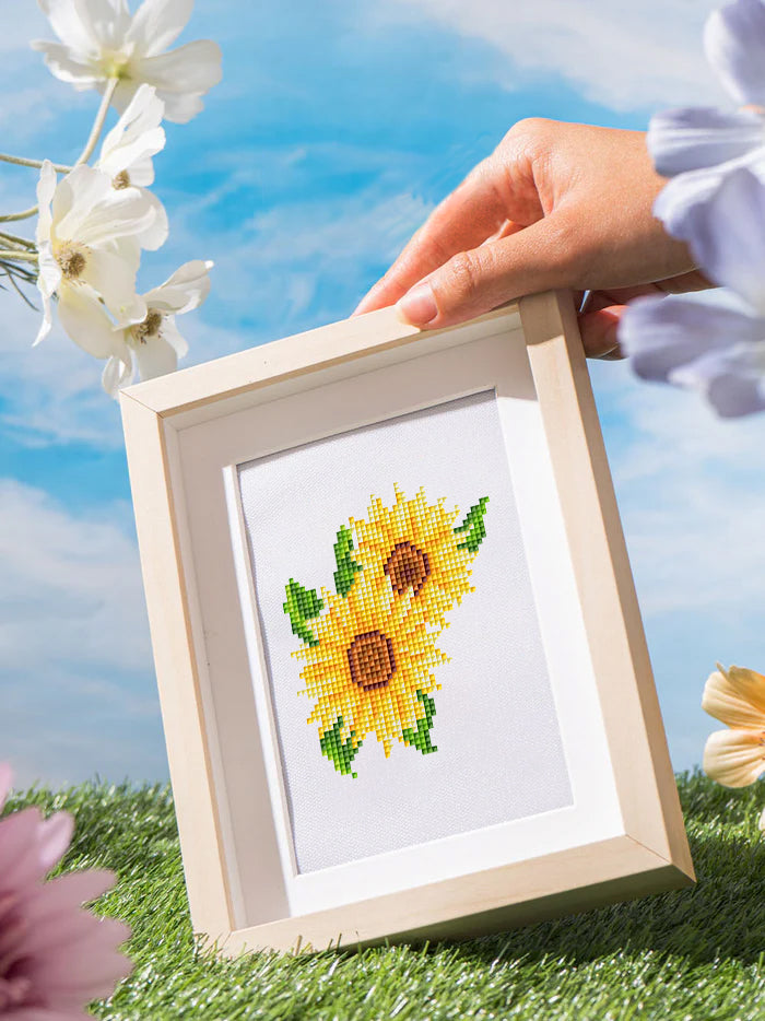 Sunflower diamond painting artwork held in sunlight, ideal for nature lovers who enjoy floral DIY kits.this small diamond painting showcased outdoors, bringing calm garden energy into your space.

