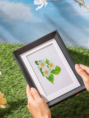 Small white Sunflower diamond painting artwork held in sunlight, ideal for beginner& nature lovers who enjoy floral DIY kits.
