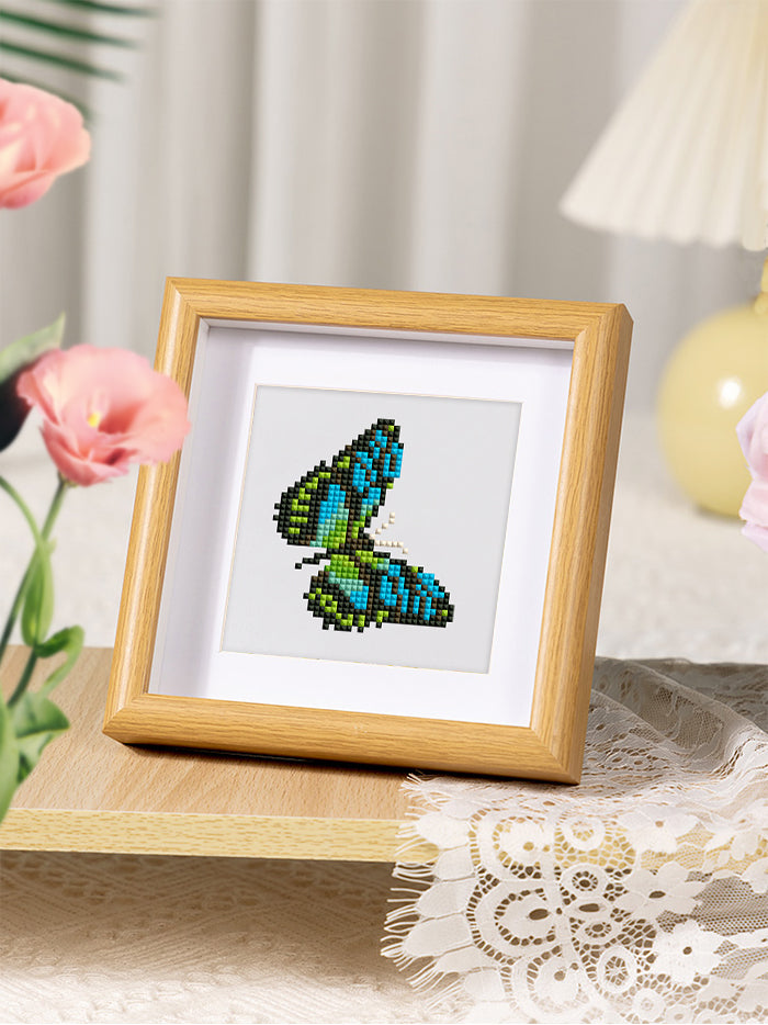 Green and blue butterfly diamond painting on white background, ideal for DIY butterfly diamond painting kits.
