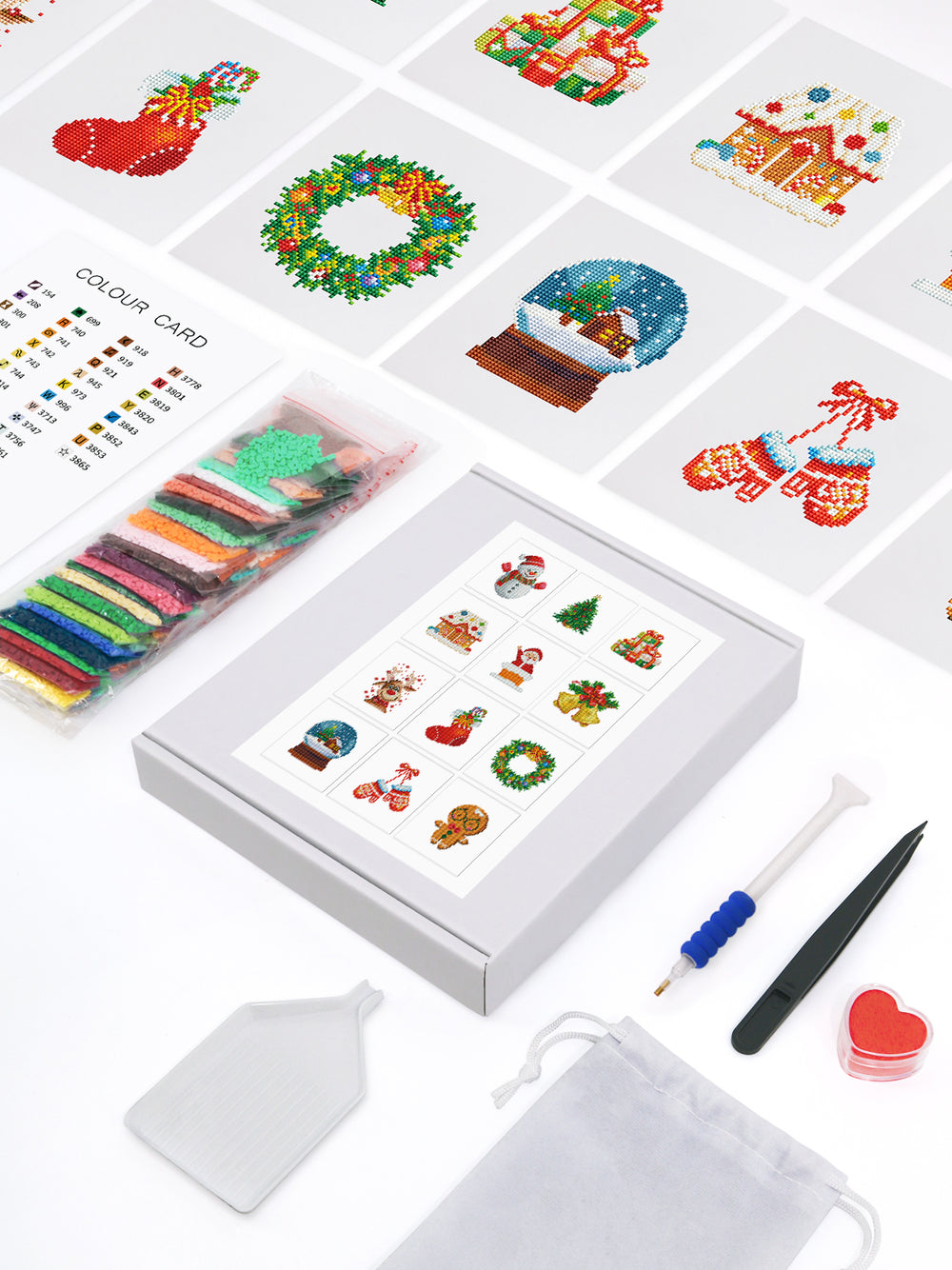 Flat lay of Christmas Magic diamond painting kit showing all holiday-themed tools and materials.
