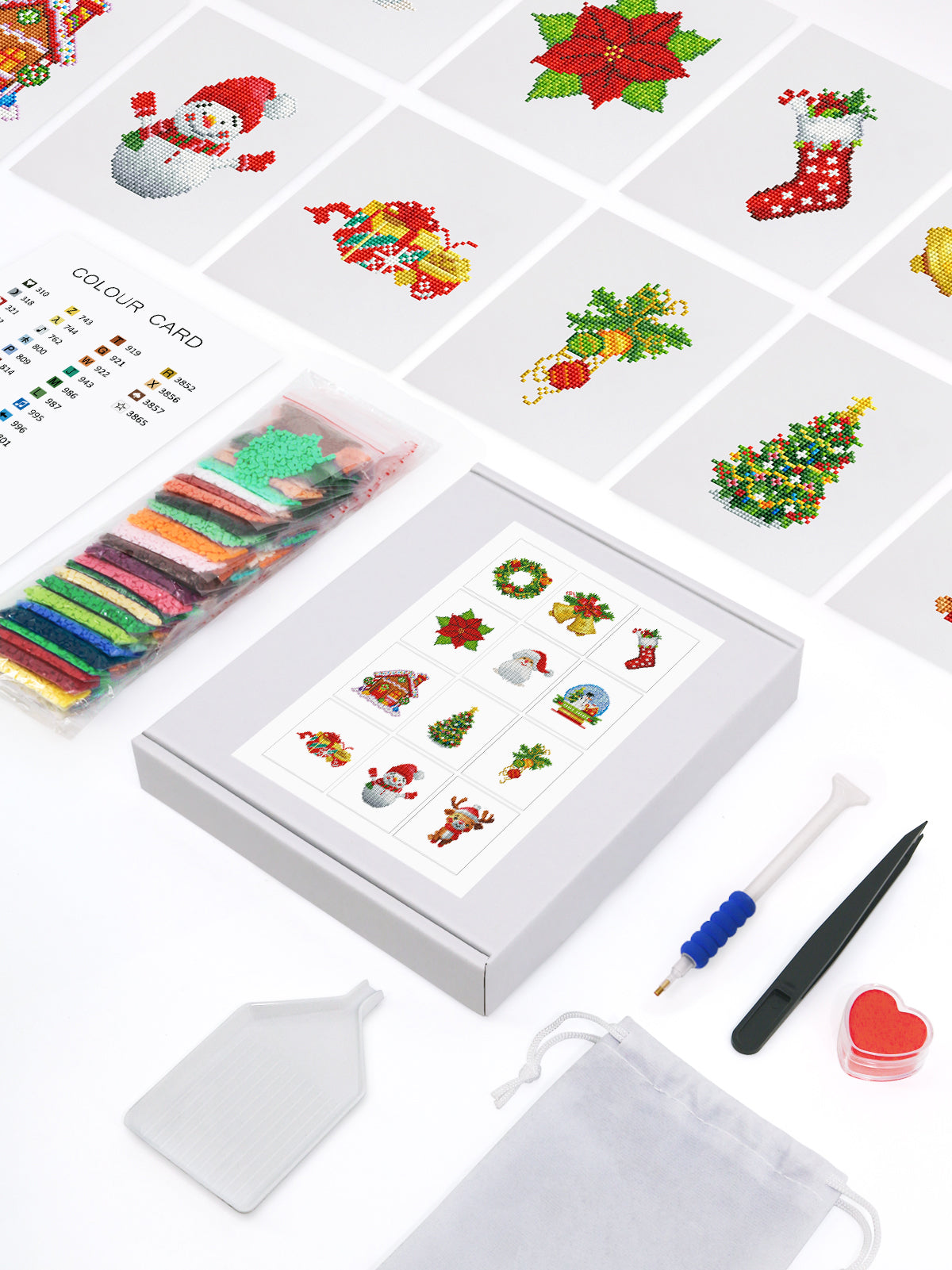 Top-down view of a Christmas diamond painting kit including resin drills, tools, and soft canvas. A complete kit for easy holiday crafting.