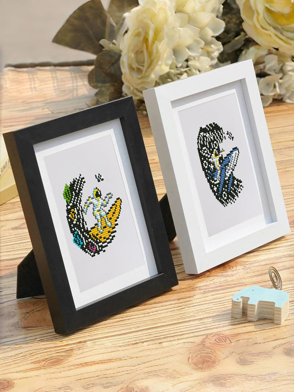 Monochrome astronaut design framed on sofa edge with books – ideal for modern living rooms.
