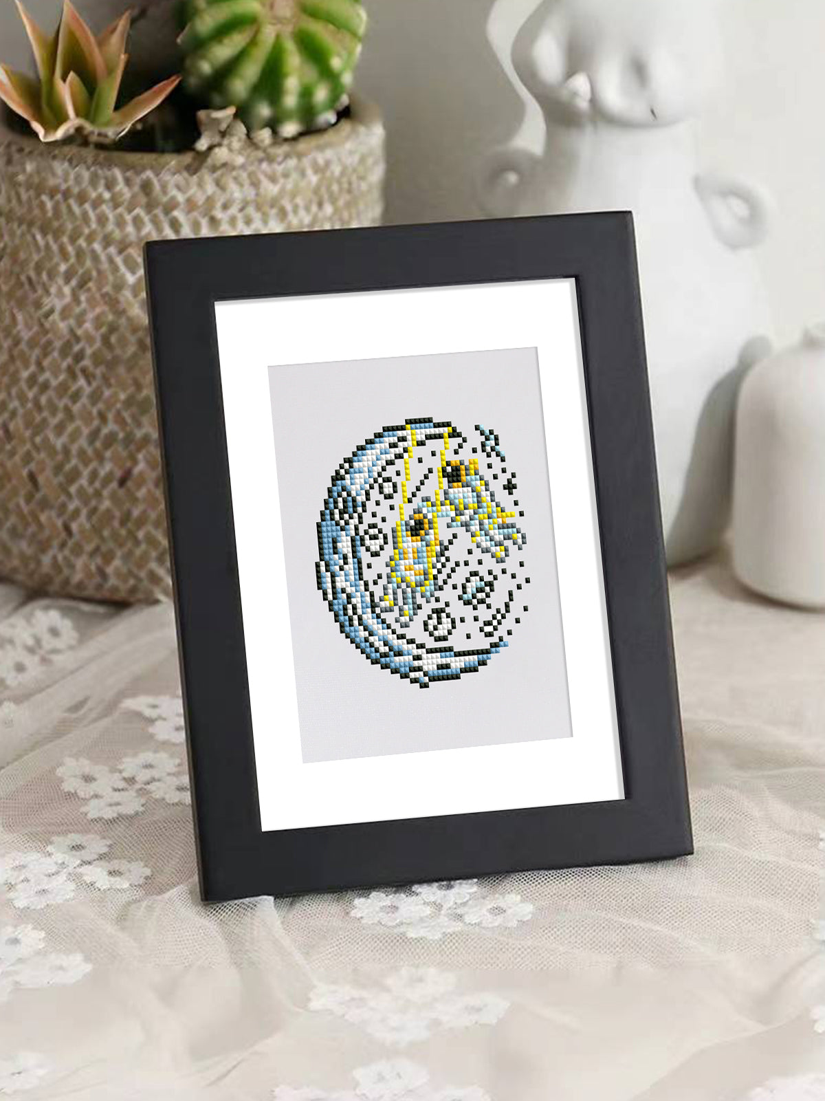 Framed duo of green alien and planet diamond painting designs on wooden stand – charming display.
