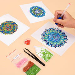 Hands working on mandala diamond painting with pen and drills，with canvas in calming blue and green tones – easy and fun craft for beginners