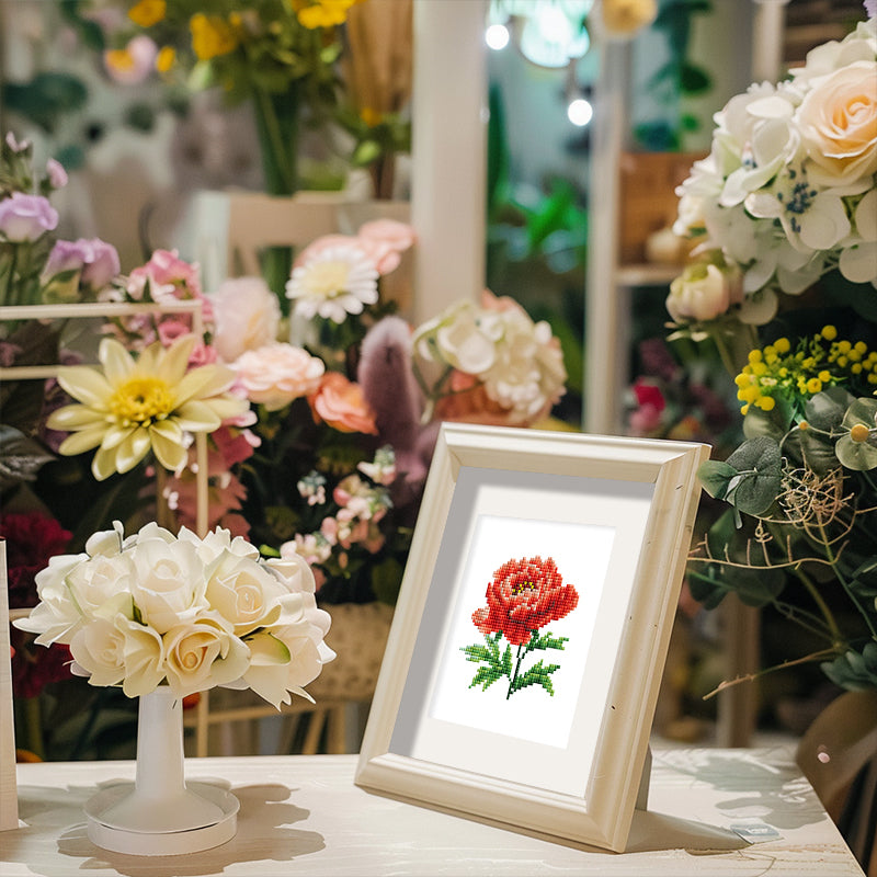 Red Peony floral diamond painting framed and displayed among fresh flowers – perfect handmade decoration