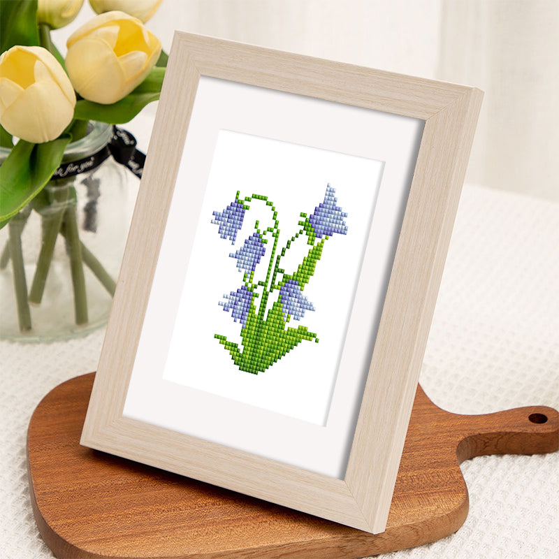 Framed Lily of the Valley diamond painting placed on wooden tray – elegant floral home décor idea from DIY kit