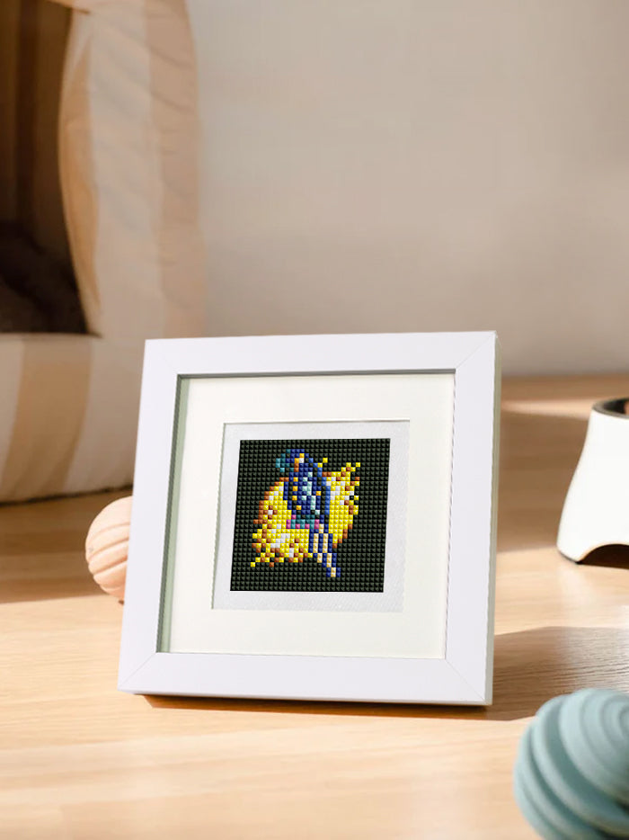 Close-up of a completed futuristic animal mini diamond painting in a white frame on a wood table.
