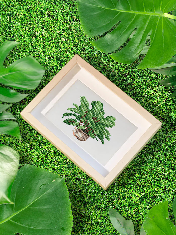 Lush green leafy diamond painting displayed in a natural setting, perfect for adding a calming garden aesthetic to your desk or home.

