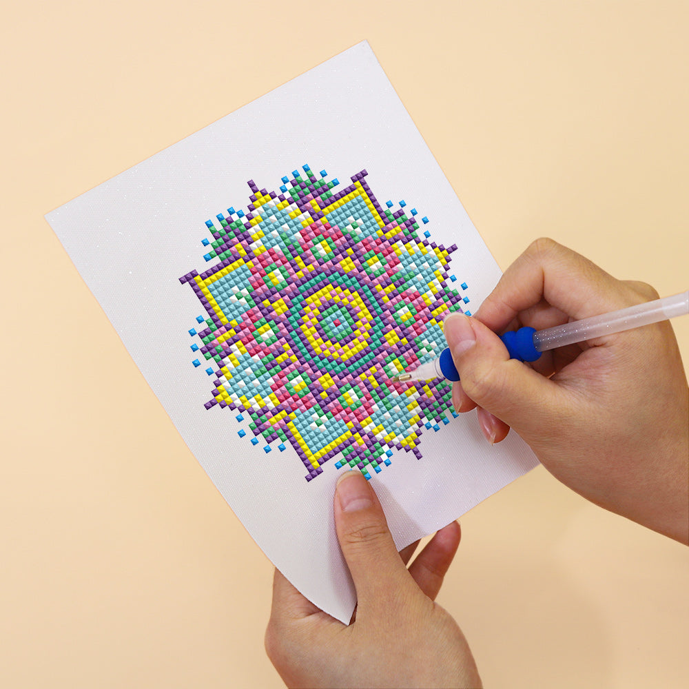 Detailed close-up of a mandala diamond painting in progress, using resin drills on soft canvas