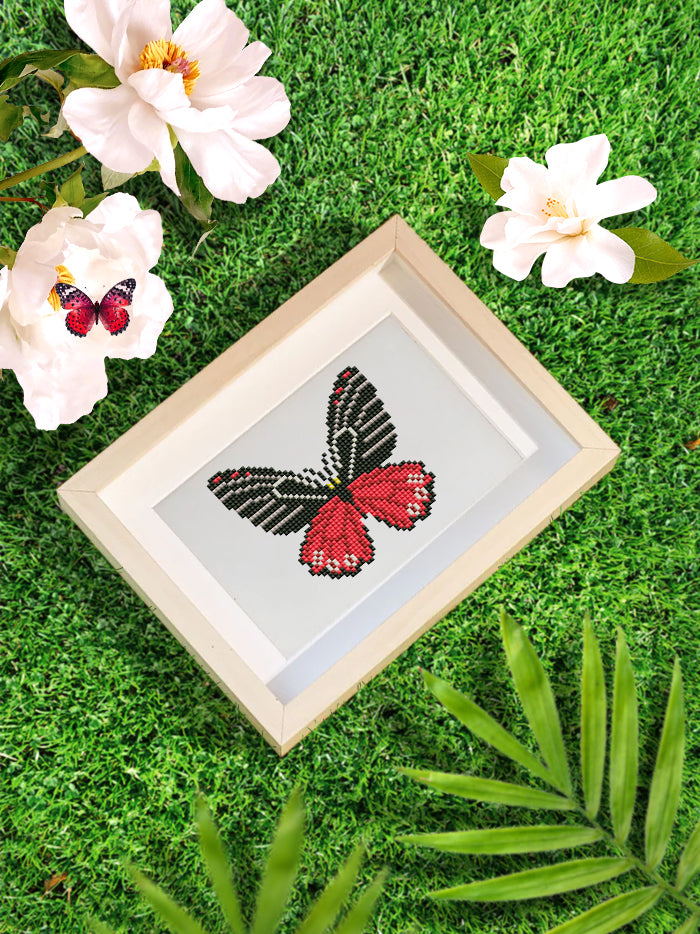 Red butterfly diamond painting framed and styled with floral accents – part of the DIY mini butterfly kit collection.