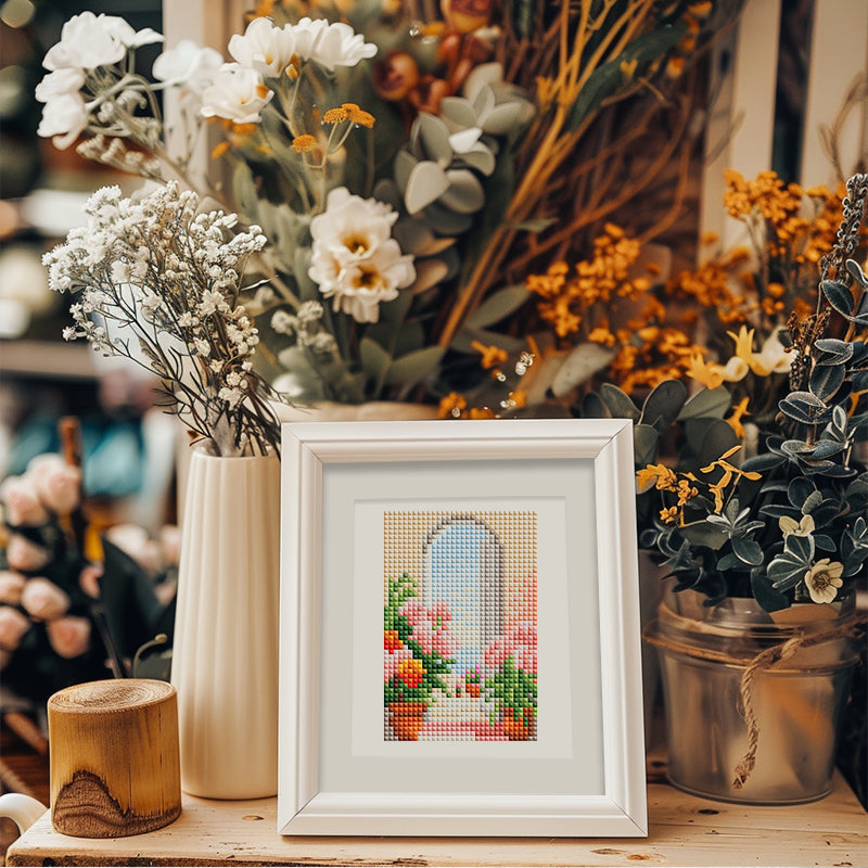 Mini diamond painting of a flowered window in white frame, placed on a table for stylish home decoration.