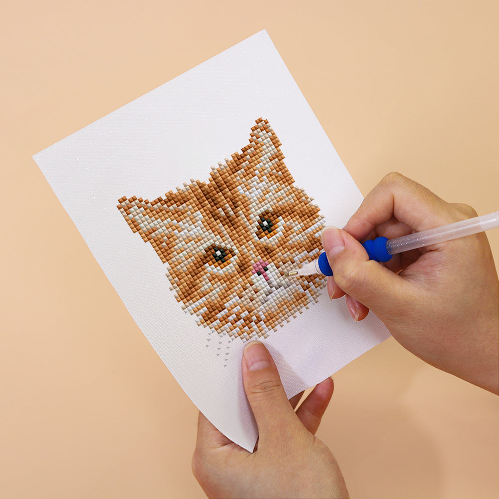 Close-up of orange tabby cat diamond painting in progress – detailed resin drills for mindful, relaxing crafting
