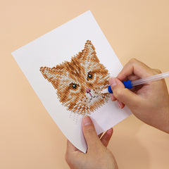 Close-up of orange tabby cat diamond painting in progress – detailed resin drills for mindful, relaxing crafting